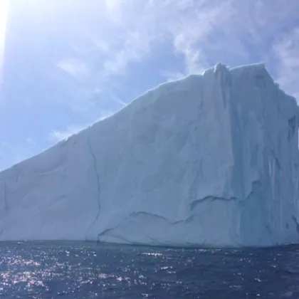 a large body of water with a mountain in the background
