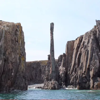 a rocky cliff by the water